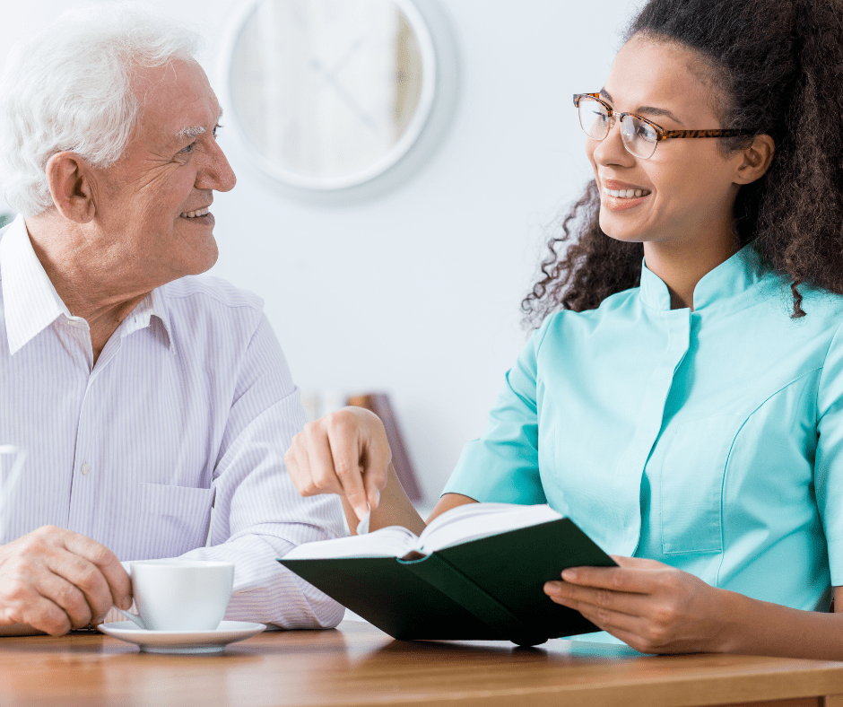 Home Care Consultation | Loving Hands Homecare Agency Caregiver reviewing information with an older adult during an in-home care visit