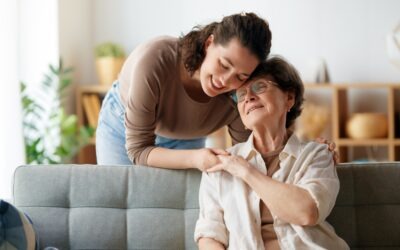 Family caregiver comforting and supporting an older adult at home.