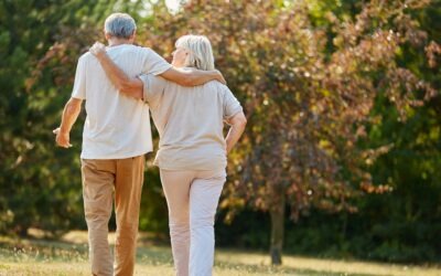 Older couple enjoying a walk outdoors during summer while staying active and healthy in Eaton Rapids, Michigan.